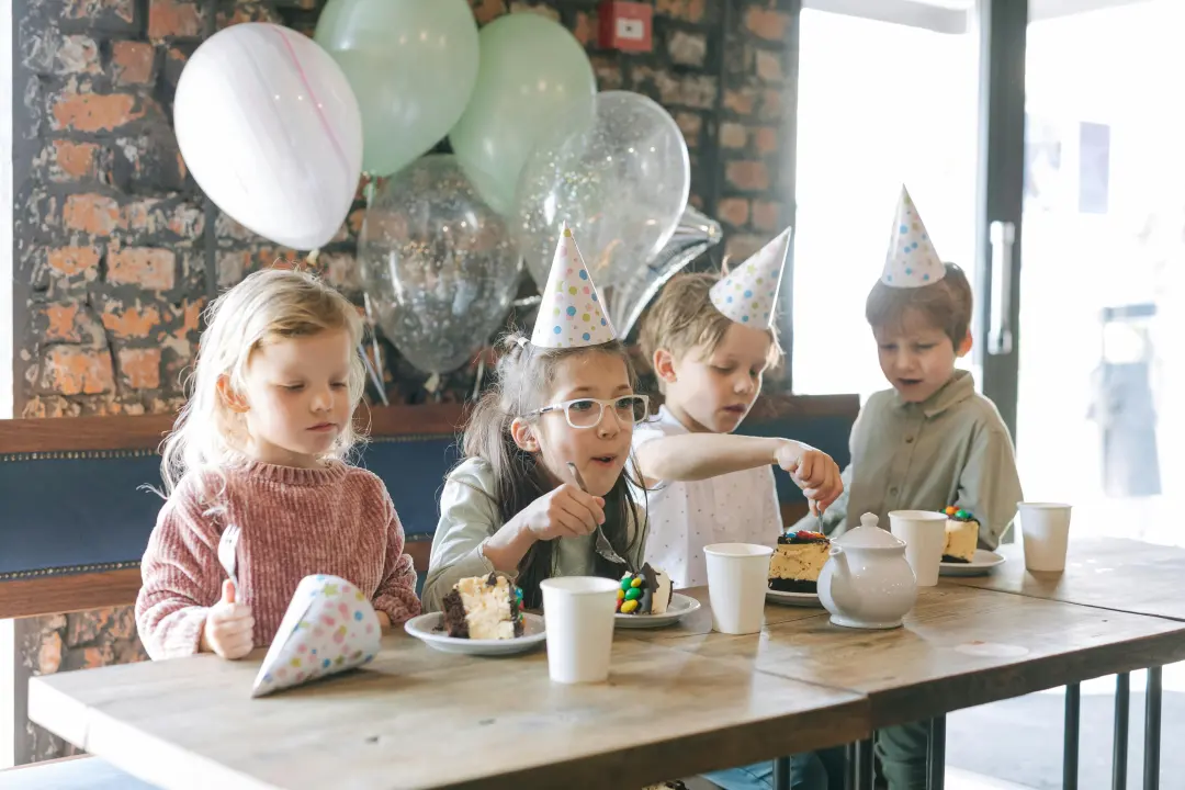 Children enjoying a colorful birthday celebration at Little Minds